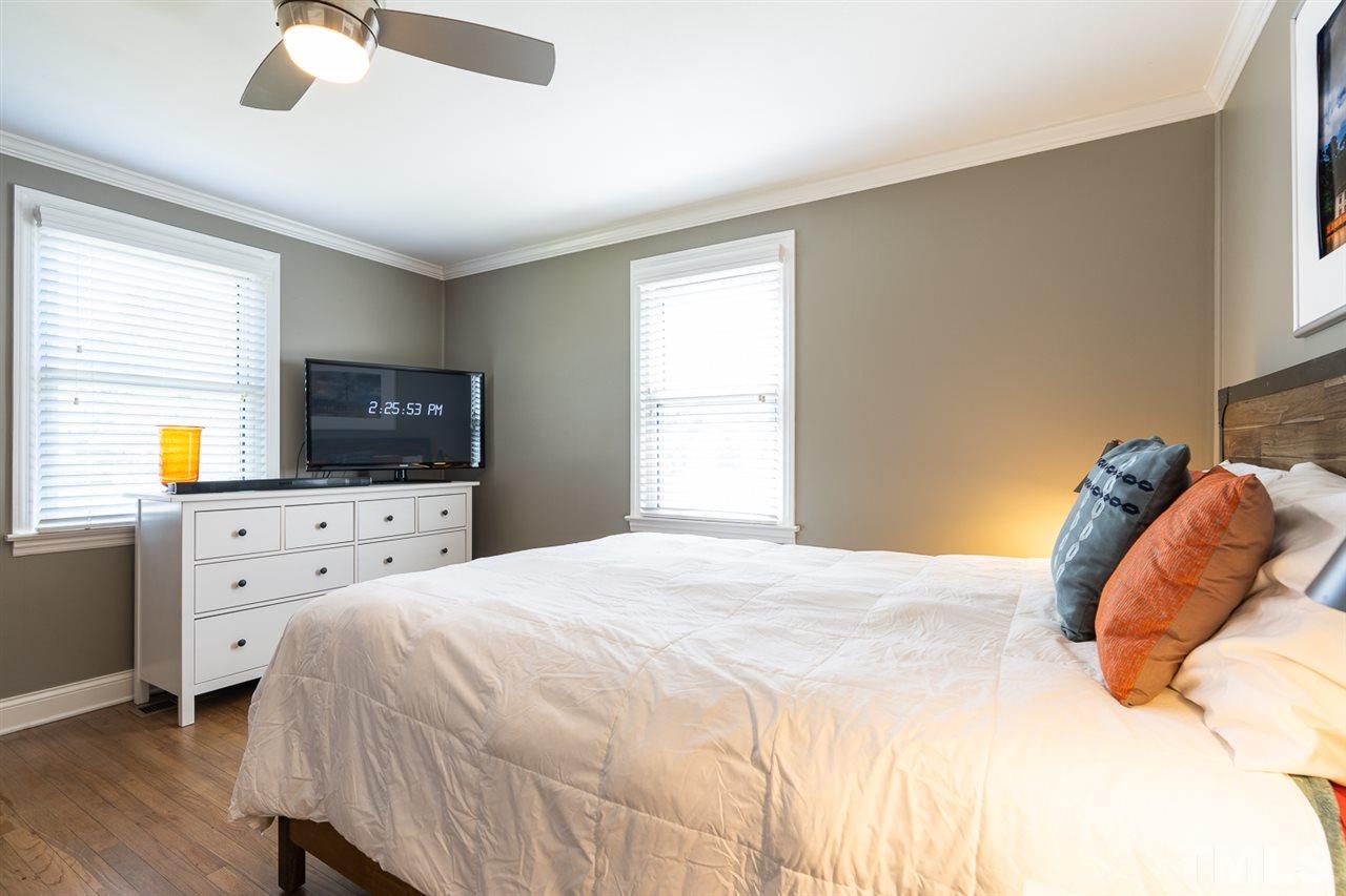 701 North King Charles Road Raleigh, NC 27610 - Photo 19 of 28 a bedroom with a bed and a flat screen tv