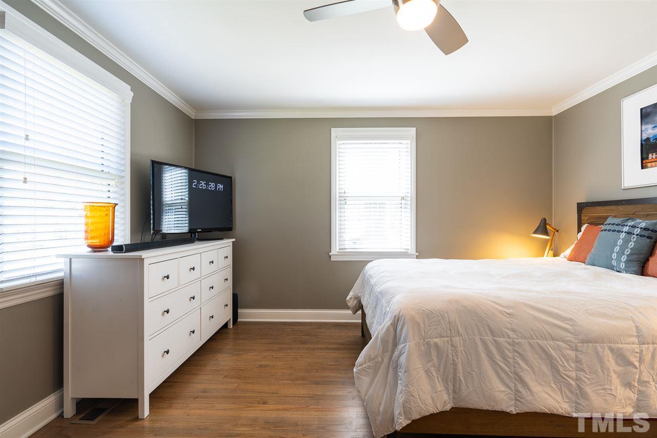 701 North King Charles Road Raleigh, NC 27610 - Photo 20 of 28 a bedroom with a bed and wooden floor