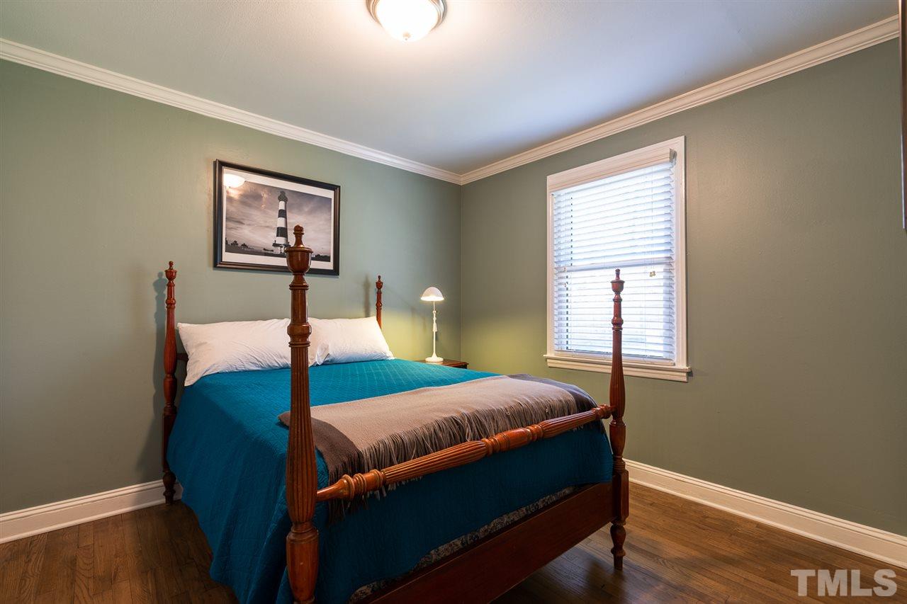 701 North King Charles Road Raleigh, NC 27610 - Photo 21 of 28 a bedroom with a bed and wooden floor
