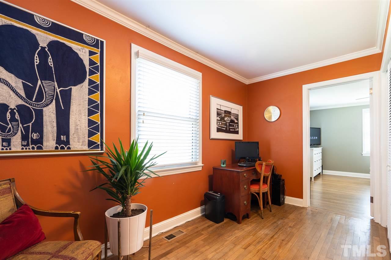 701 North King Charles Road Raleigh, NC 27610 - Photo 22 of 28 a view of a workspace room with wooden floor and furniture