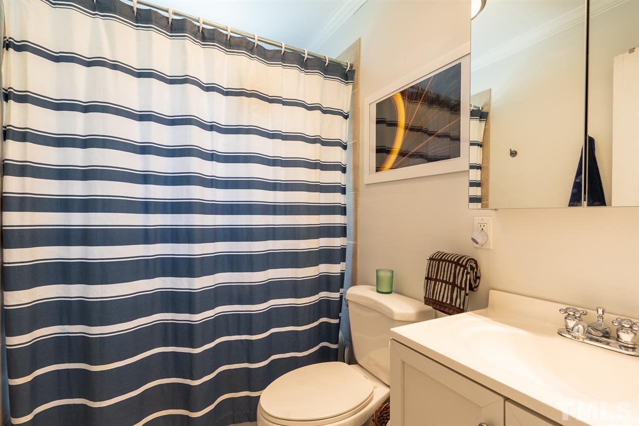 701 North King Charles Road Raleigh, NC 27610 - Photo 24 of 28 a bathroom with a sink and a mirror