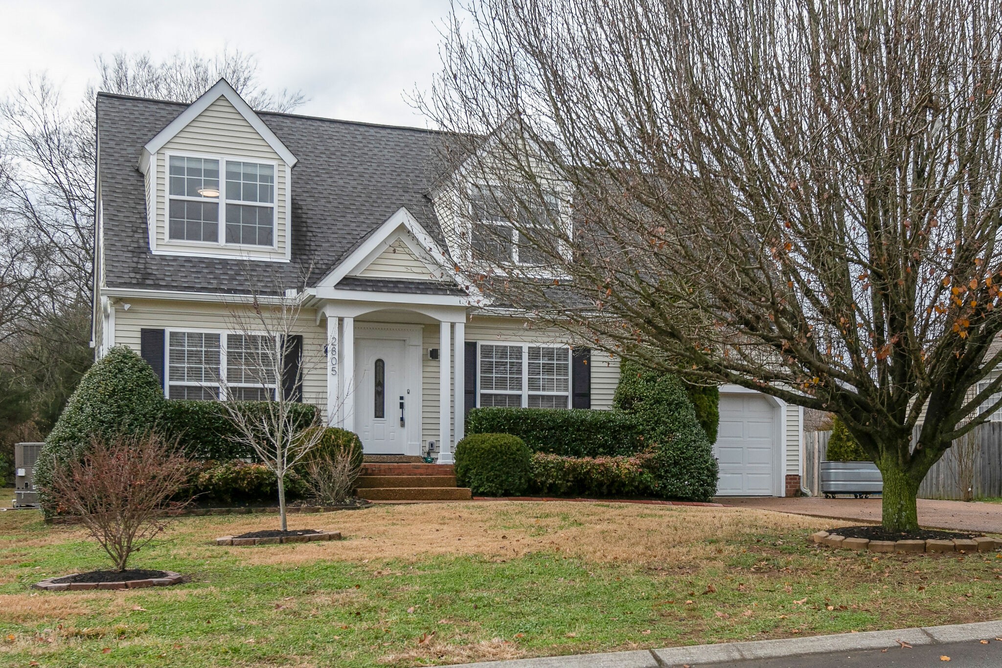 2805 Rippavilla Way Spring Hill, TN 37174 - Photo 1 of 30 a front view of a house with a yard and potted plants