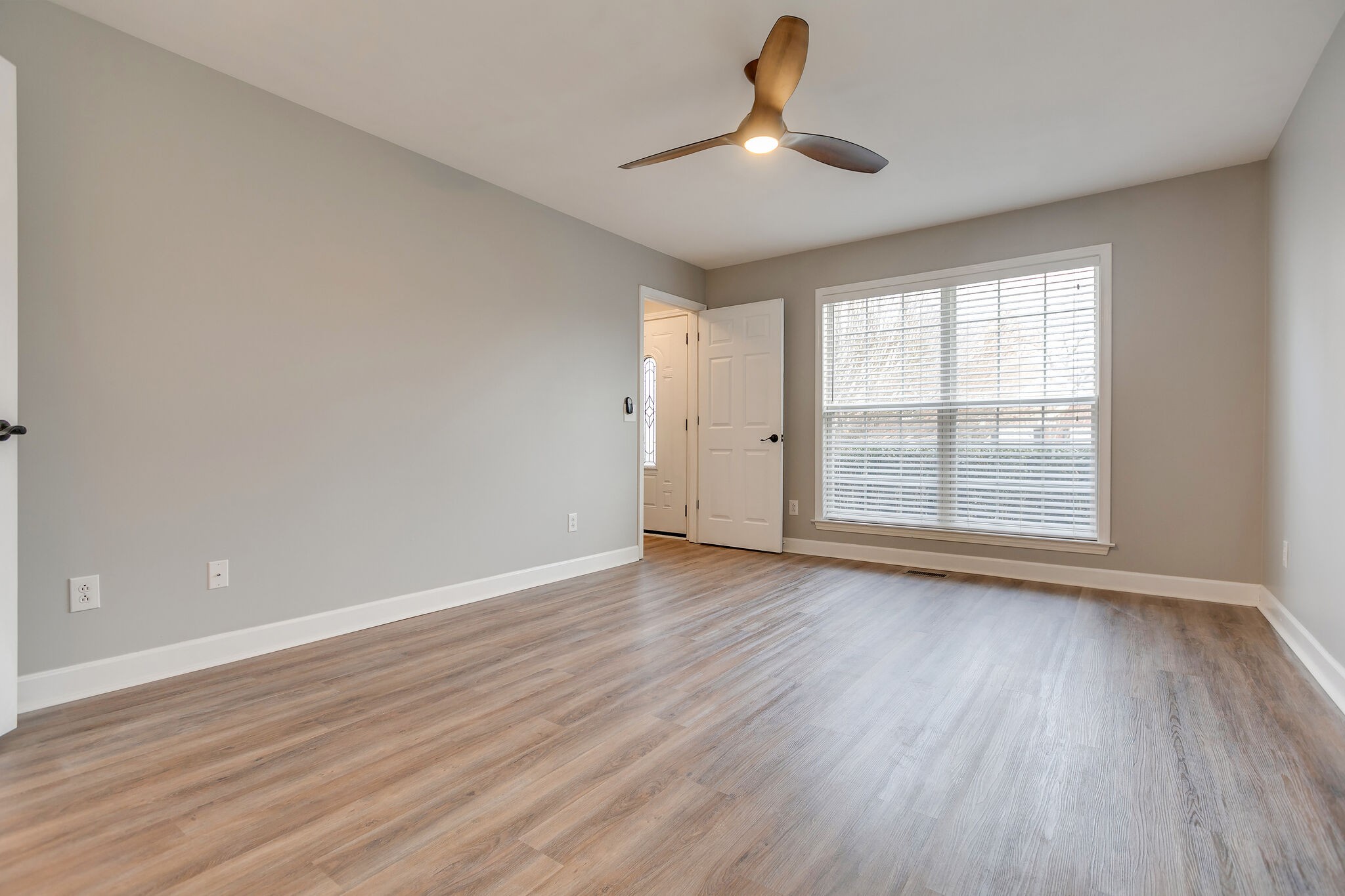 2805 Rippavilla Way Spring Hill, TN 37174 - Photo 16 of 30 an empty room with wooden floor ceiling fan and windows