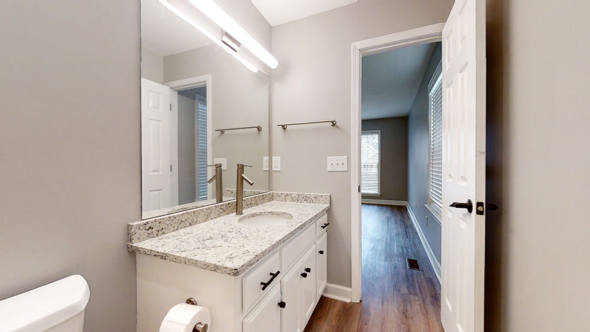 2805 Rippavilla Way Spring Hill, TN 37174 - Photo 18 of 30 a bathroom with a granite countertop sink a toilet and a mirror