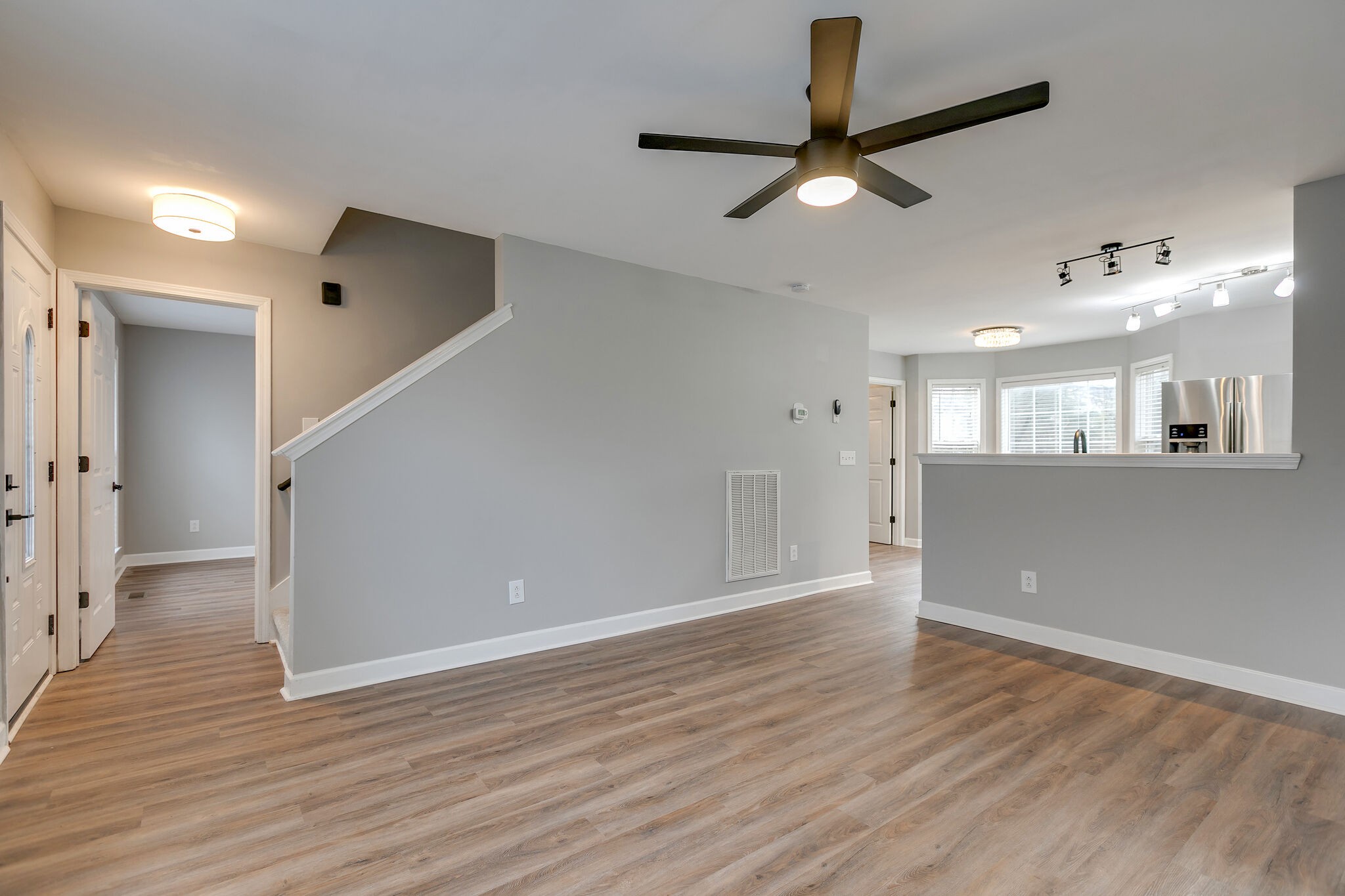 2805 Rippavilla Way Spring Hill, TN 37174 - Photo 7 of 30 a view of an empty room with wooden floor and a ceiling fan