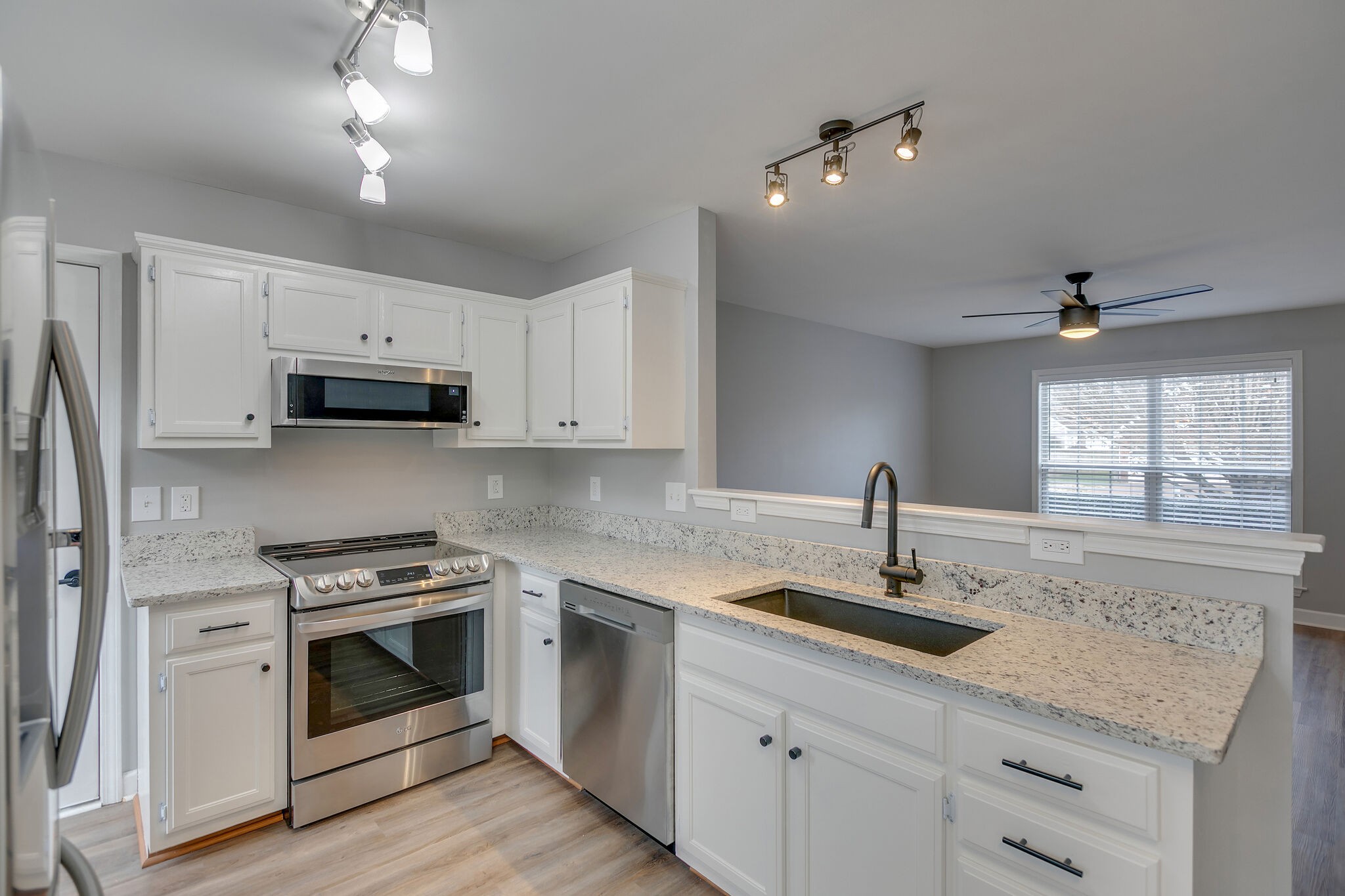 2805 Rippavilla Way Spring Hill, TN 37174 - Photo 10 of 30 a kitchen with stainless steel appliances granite countertop a sink stove and microwave