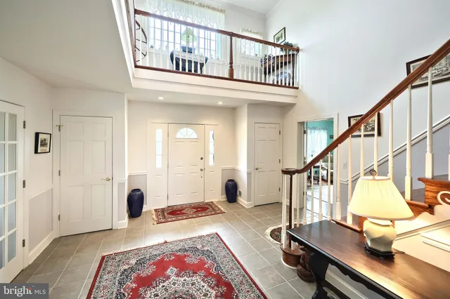 a spacious bedroom with a bed and a large window