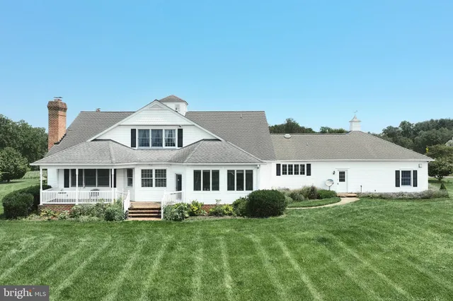 a front view of a house with a yard table and chairs