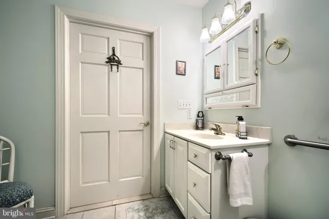 a spacious bathroom with a double vanity sink a mirror a and a shower