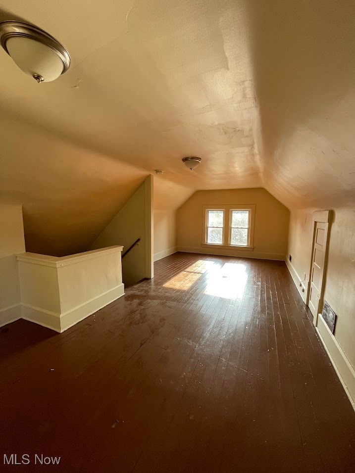 950 Avon Street Akron, OH 44310 - Photo 15 of 15 Additional living space featuring dark wood-type flooring and vaulted ceiling