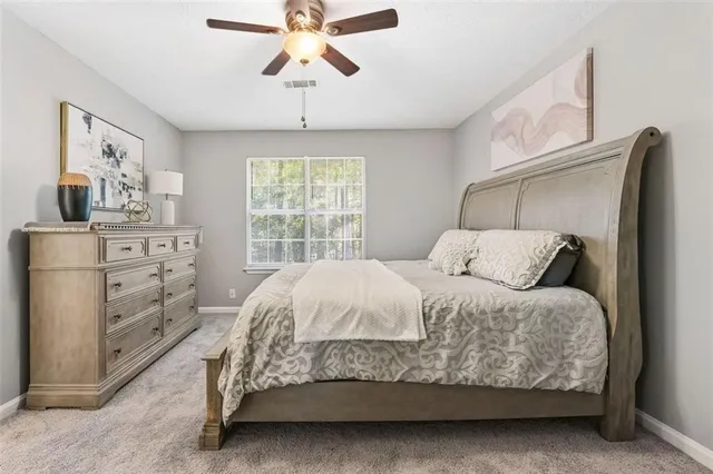 a large bed sitting in a bedroom next to a window