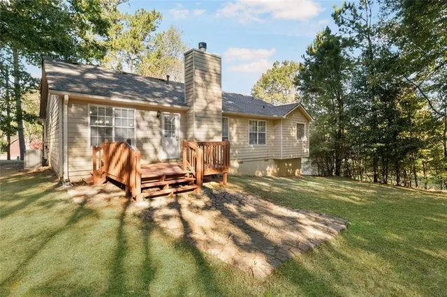 a view of a house with backyard and sitting area