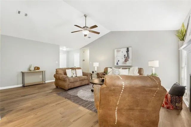 a living room with furniture and a wooden floor
