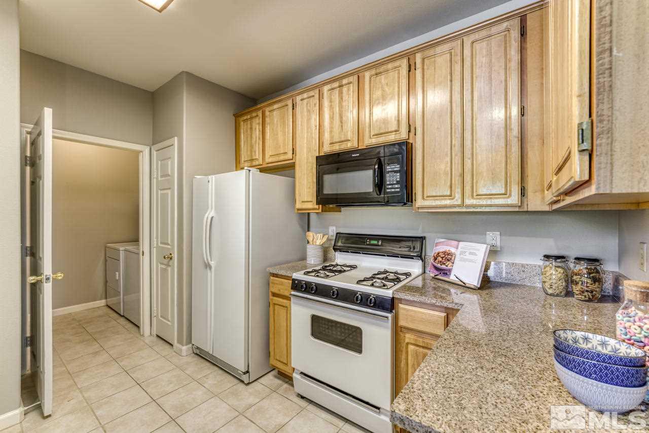 900 S, Unit 2024 Reno, NV 89521 - Photo 15 of 32 a kitchen with stainless steel appliances granite countertop a stove a sink and a refrigerator