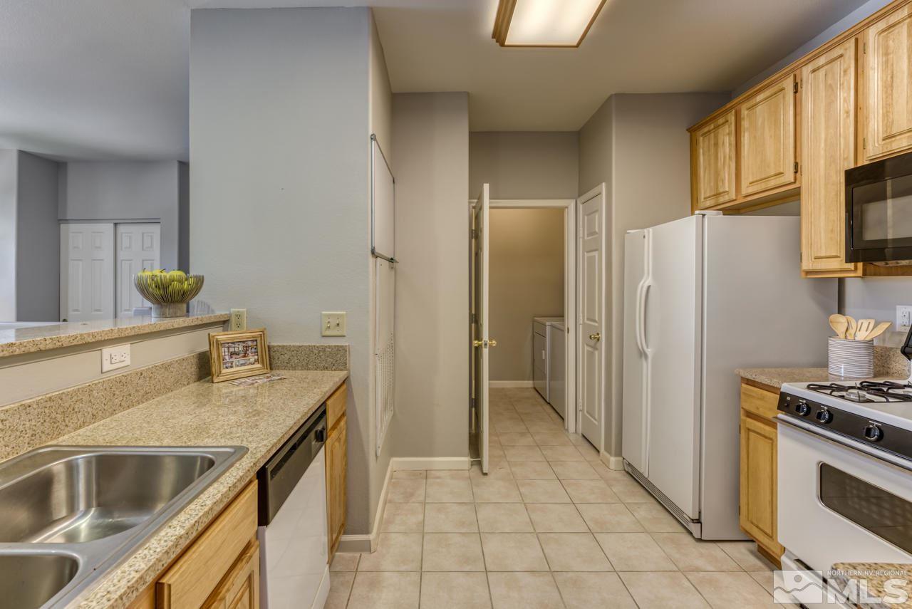 900 S, Unit 2024 Reno, NV 89521 - Photo 16 of 32 a kitchen with stainless steel appliances granite countertop a sink stove and refrigerator