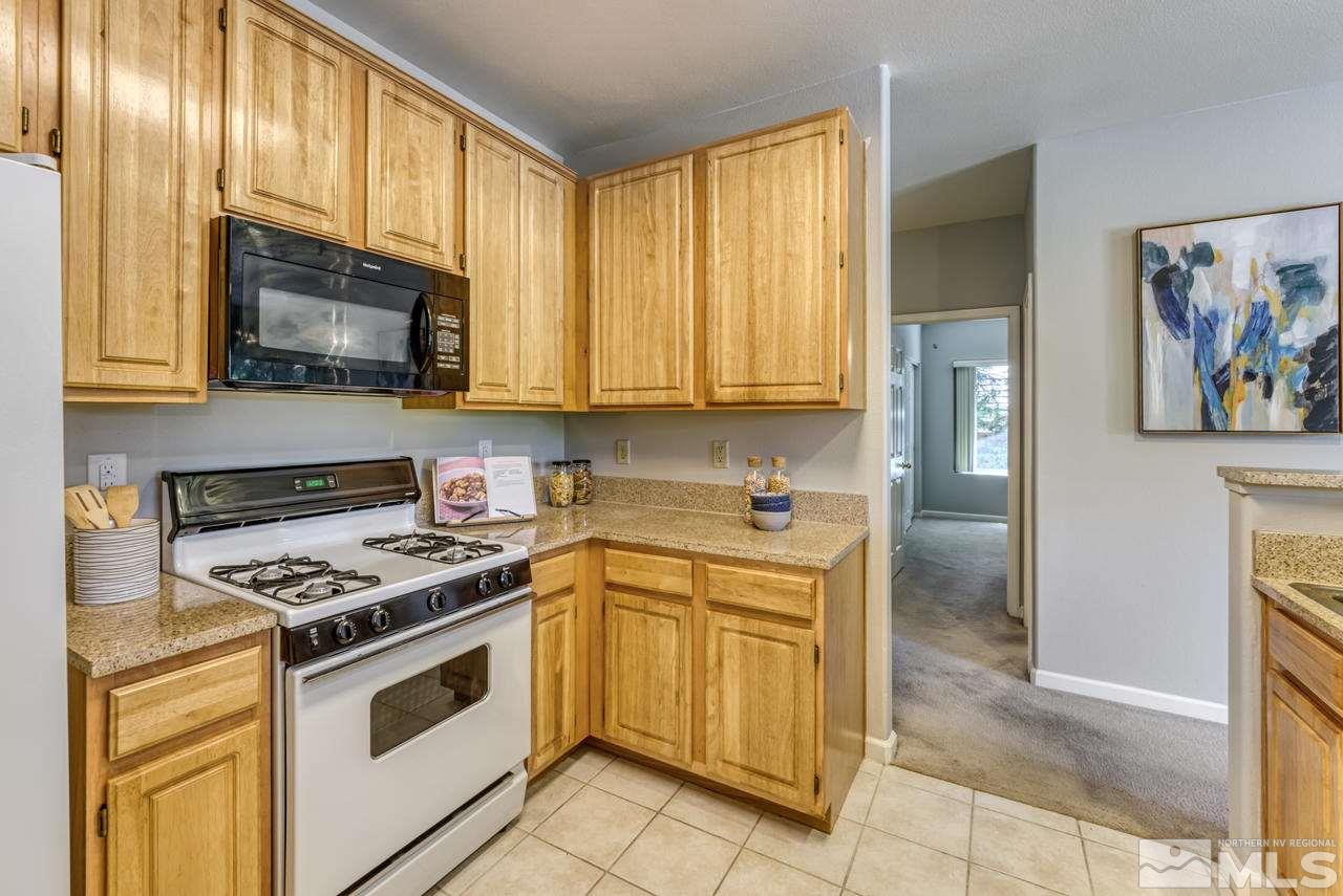 900 S, Unit 2024 Reno, NV 89521 - Photo 17 of 32 a kitchen with stainless steel appliances granite countertop a stove a sink and a microwave