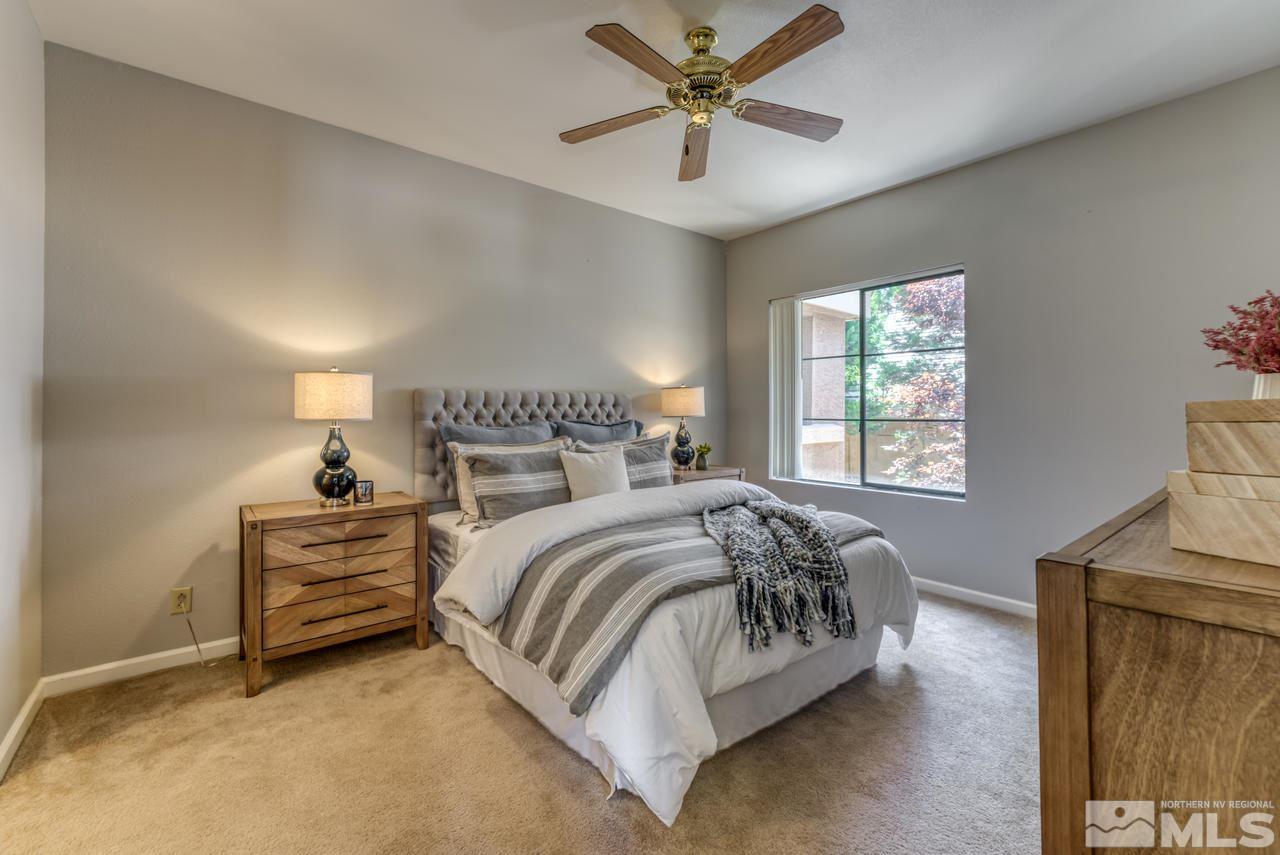 900 S, Unit 2024 Reno, NV 89521 - Photo 19 of 32 a bedroom with a bed and a chandelier