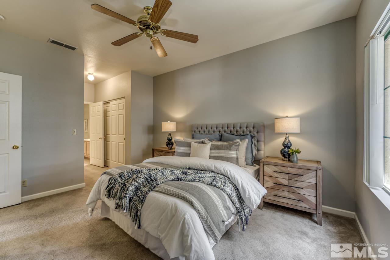 900 S, Unit 2024 Reno, NV 89521 - Photo 20 of 32 a bedroom with a bed and a chandelier