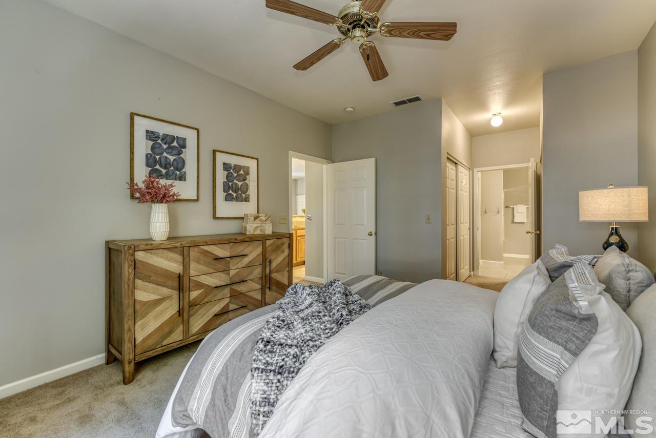 900 S, Unit 2024 Reno, NV 89521 - Photo 21 of 32 a bedroom with a bed and a chandelier