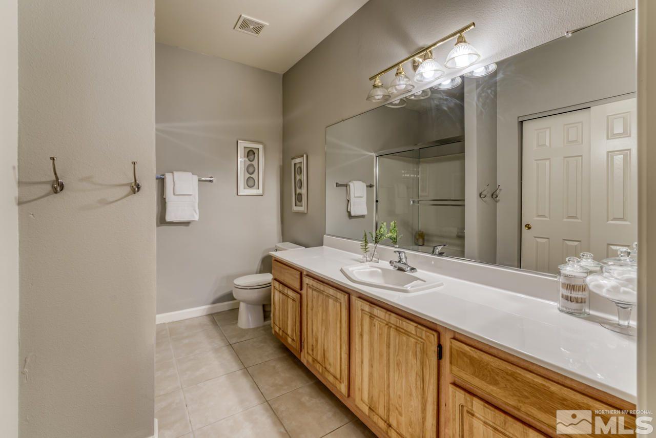 900 S, Unit 2024 Reno, NV 89521 - Photo 22 of 32 a bathroom with a double vanity sink and a mirror