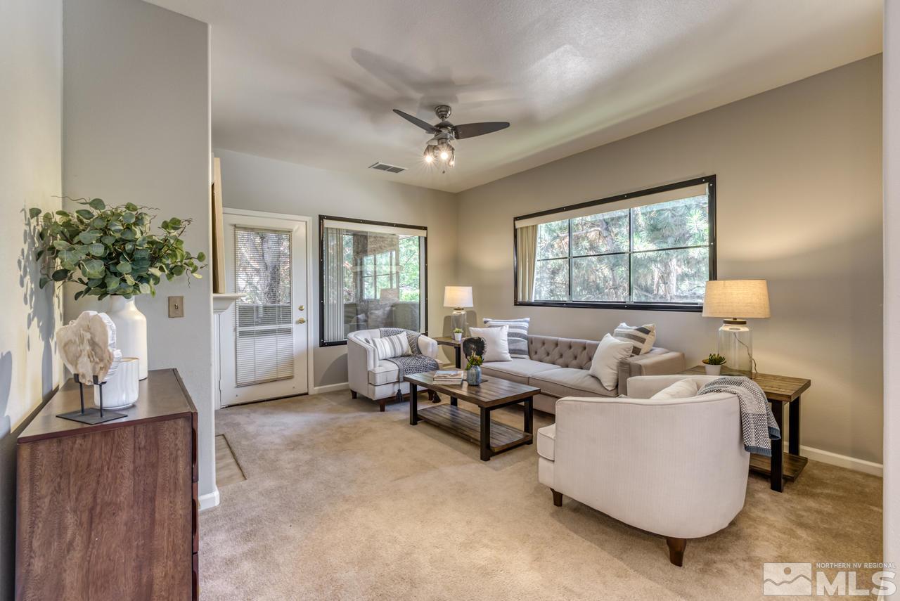 900 S, Unit 2024 Reno, NV 89521 - Photo 7 of 32 a living room with furniture a chandelier and a window