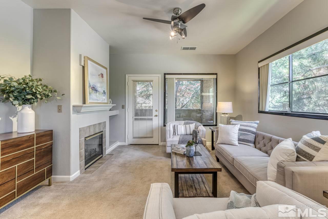 900 S, Unit 2024 Reno, NV 89521 - Photo 8 of 32 a living room with furniture a fireplace and a flat screen tv