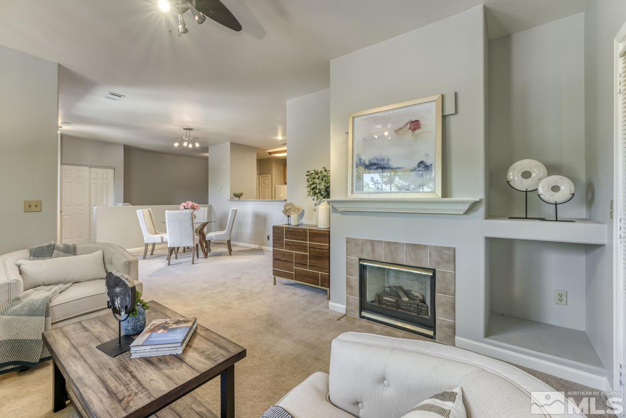 900 S, Unit 2024 Reno, NV 89521 - Photo 10 of 32 a living room with furniture a fireplace and wall paintings