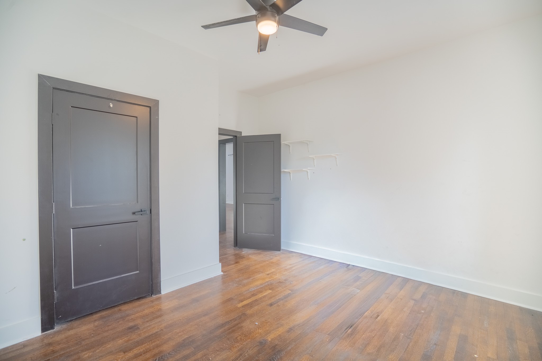 7305 Capitol Street Houston, TX 77011 - Photo 11 of 16 an empty room with wooden floor closet and ceiling fan