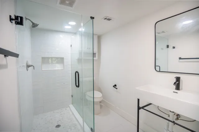 a bathroom with a shower and a sink