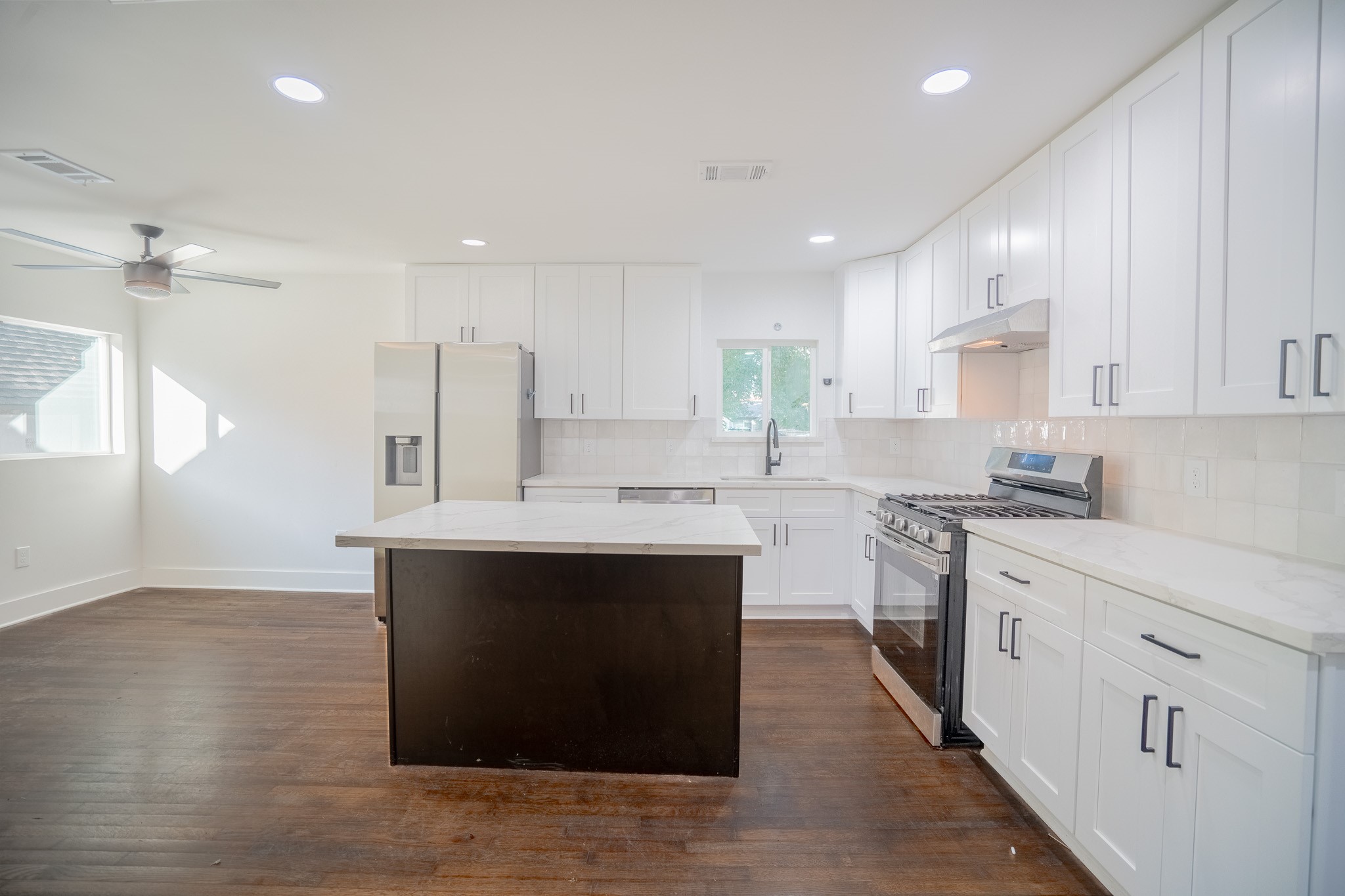 7305 Capitol Street Houston, TX 77011 - Photo 6 of 16 a kitchen with a sink cabinets and wooden floor