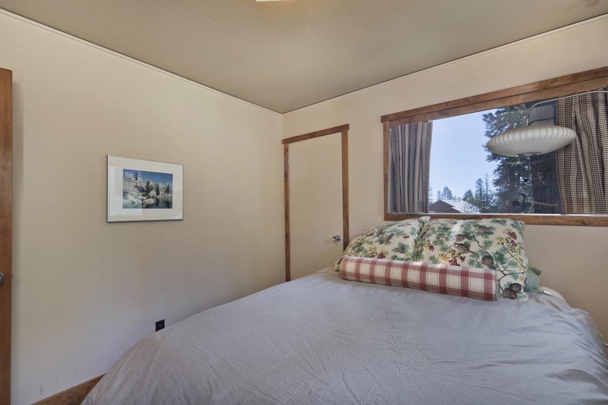 210 Convict Drive Mammoth Lakes, CA 93546 - Photo 11 of 46 a bedroom with furniture and a window