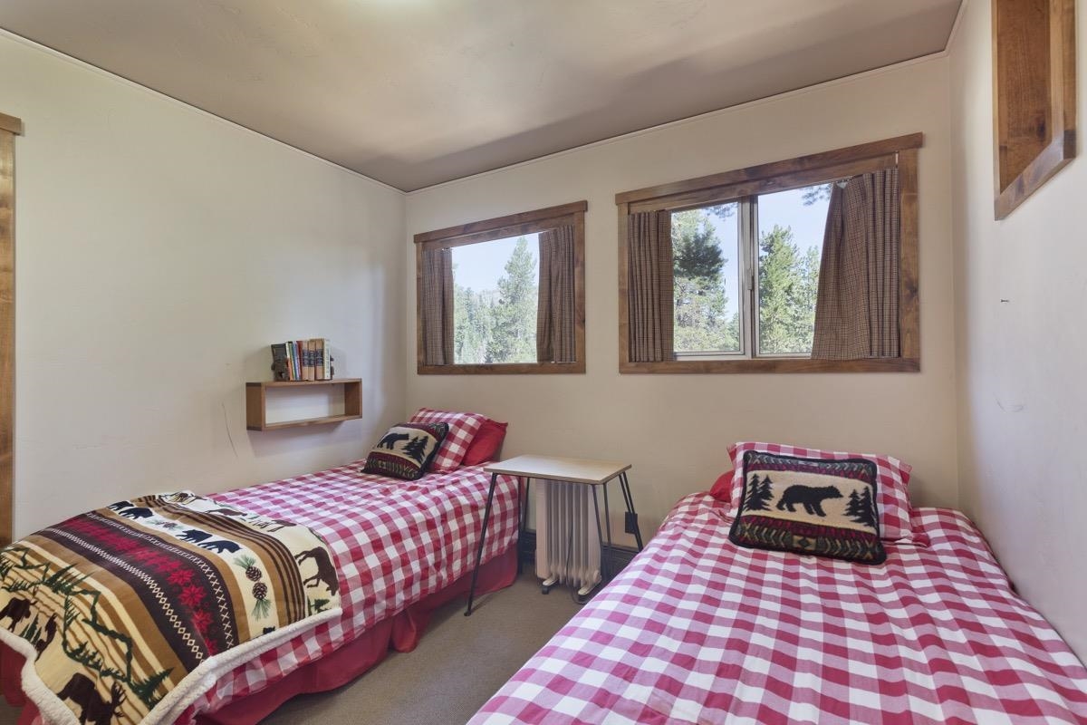 210 Convict Drive Mammoth Lakes, CA 93546 - Photo 13 of 46 a bedroom with a bed and wooden floor
