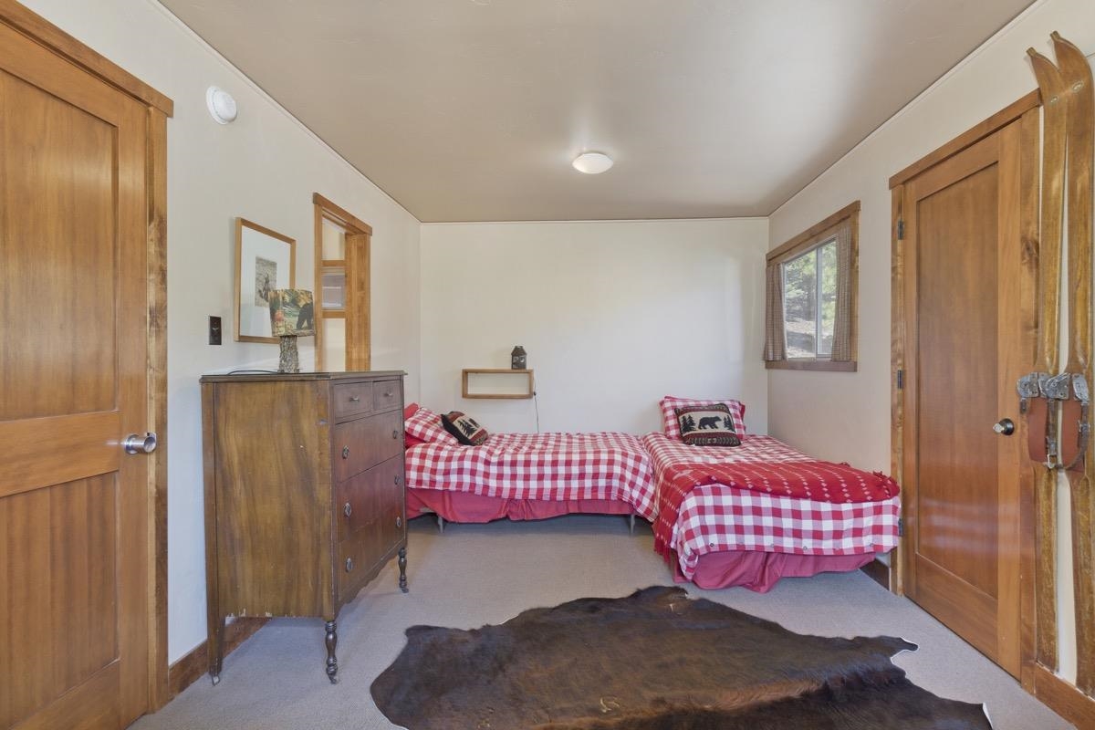 210 Convict Drive Mammoth Lakes, CA 93546 - Photo 14 of 46 a bedroom with a bed and wooden floor