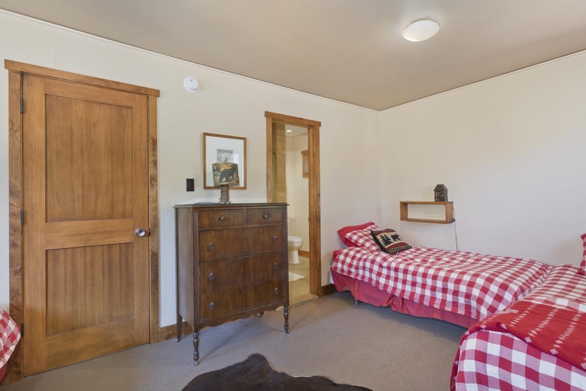 210 Convict Drive Mammoth Lakes, CA 93546 - Photo 15 of 46 a bedroom with a bed and a cabinets