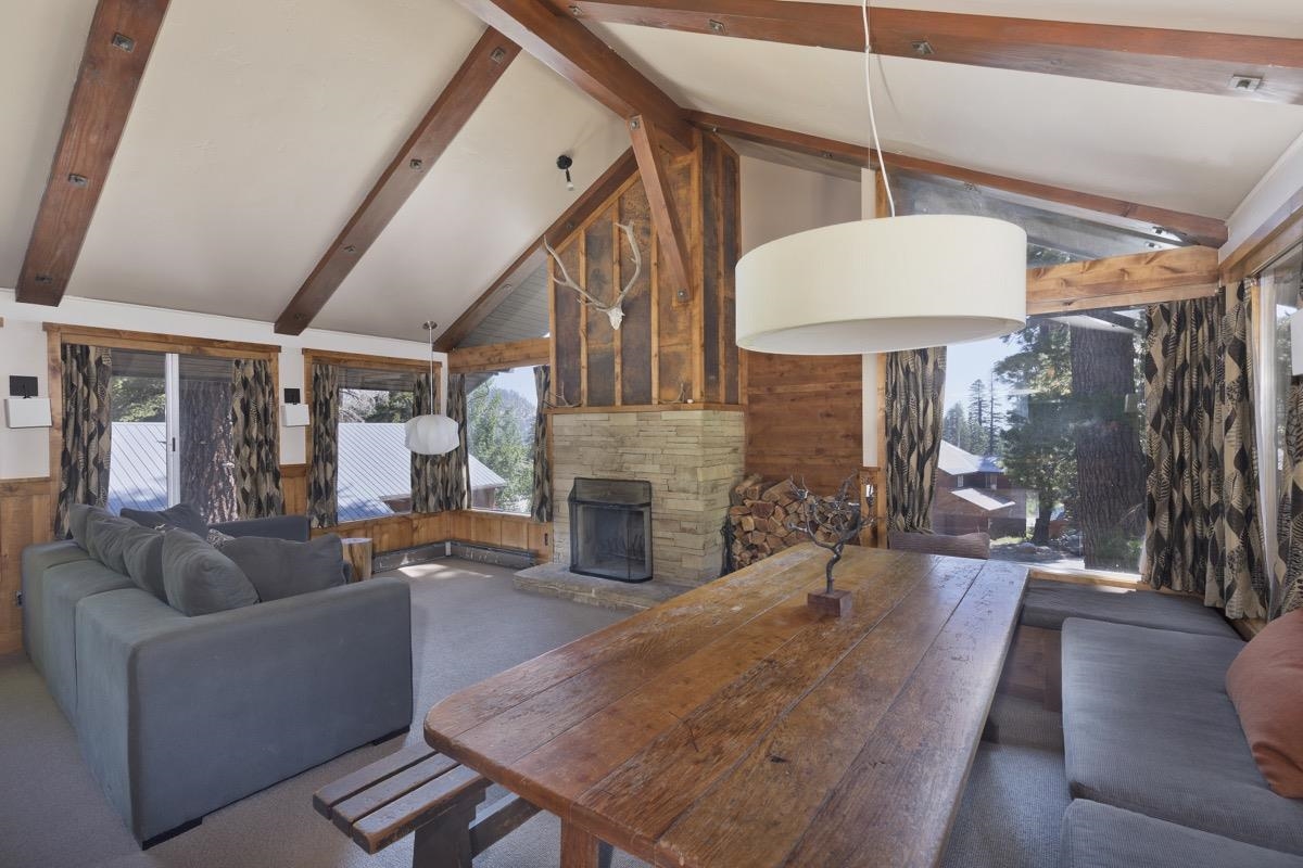 210 Convict Drive Mammoth Lakes, CA 93546 - Photo 20 of 46 a living room with furniture a fireplace and a chandelier