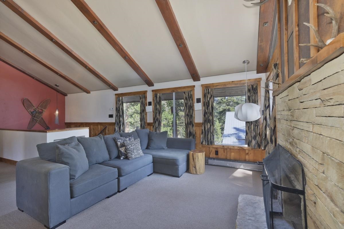 210 Convict Drive Mammoth Lakes, CA 93546 - Photo 24 of 46 a living room with furniture and a floor to ceiling window