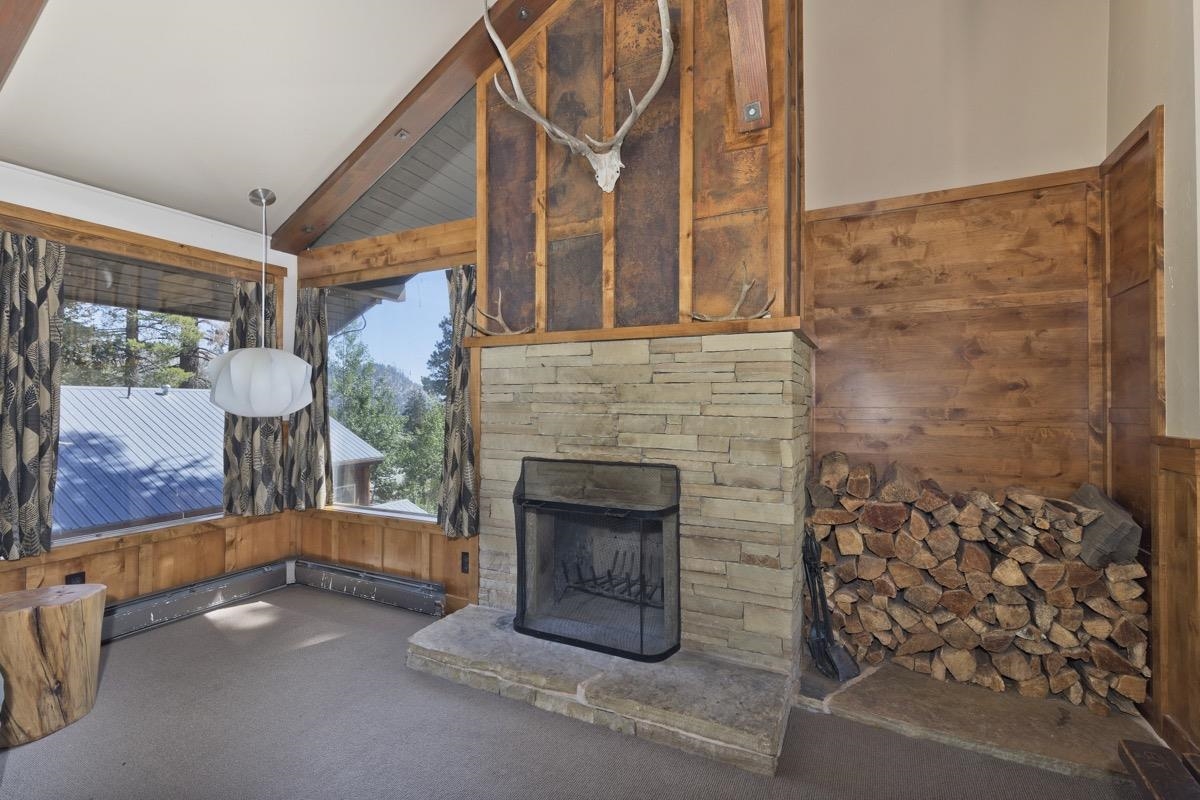 210 Convict Drive Mammoth Lakes, CA 93546 - Photo 25 of 46 a living room with a fireplace and a large window