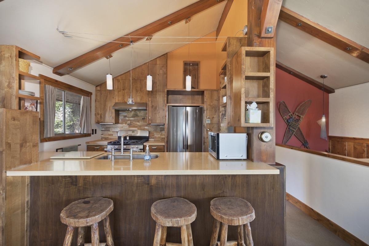 210 Convict Drive Mammoth Lakes, CA 93546 - Photo 26 of 46 a dining table with chairs and chandelier
