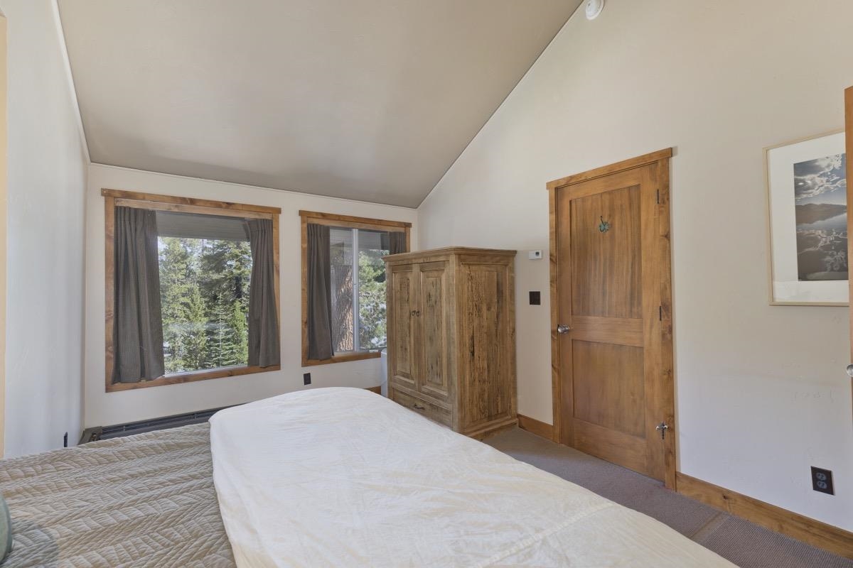 210 Convict Drive Mammoth Lakes, CA 93546 - Photo 33 of 46 a view of a bedroom with wooden floor and windows
