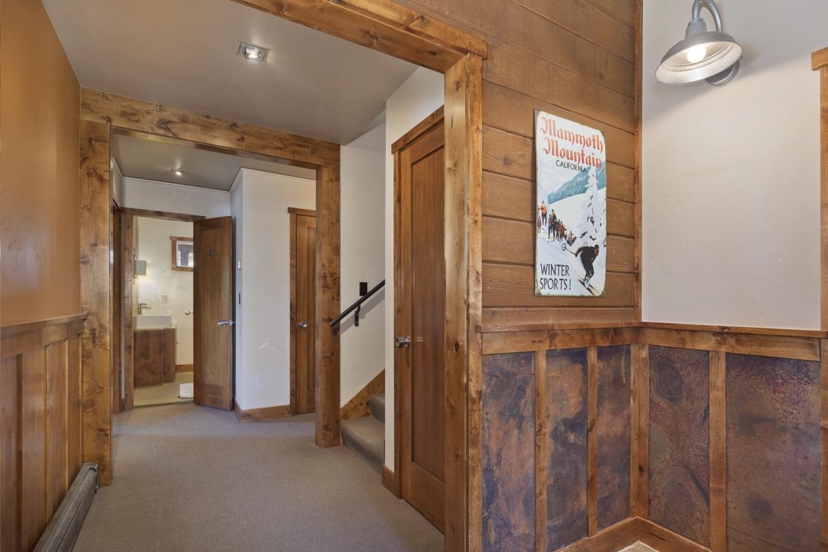 210 Convict Drive Mammoth Lakes, CA 93546 - Photo 5 of 46 a view of a hallway with paintings on the wall