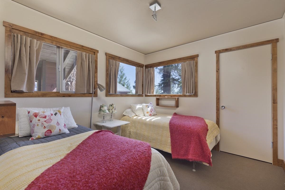 210 Convict Drive Mammoth Lakes, CA 93546 - Photo 8 of 46 a bedroom with two beds and a large window