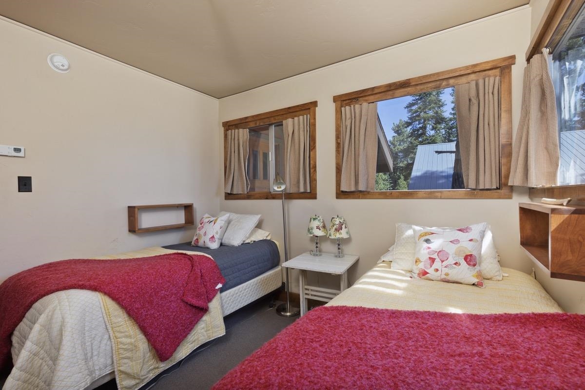 210 Convict Drive Mammoth Lakes, CA 93546 - Photo 9 of 46 a bedroom with a bed and a painting on the wall