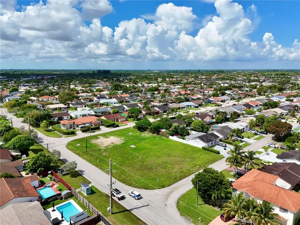 an aerial view of a residential houses with outdoor space and garden