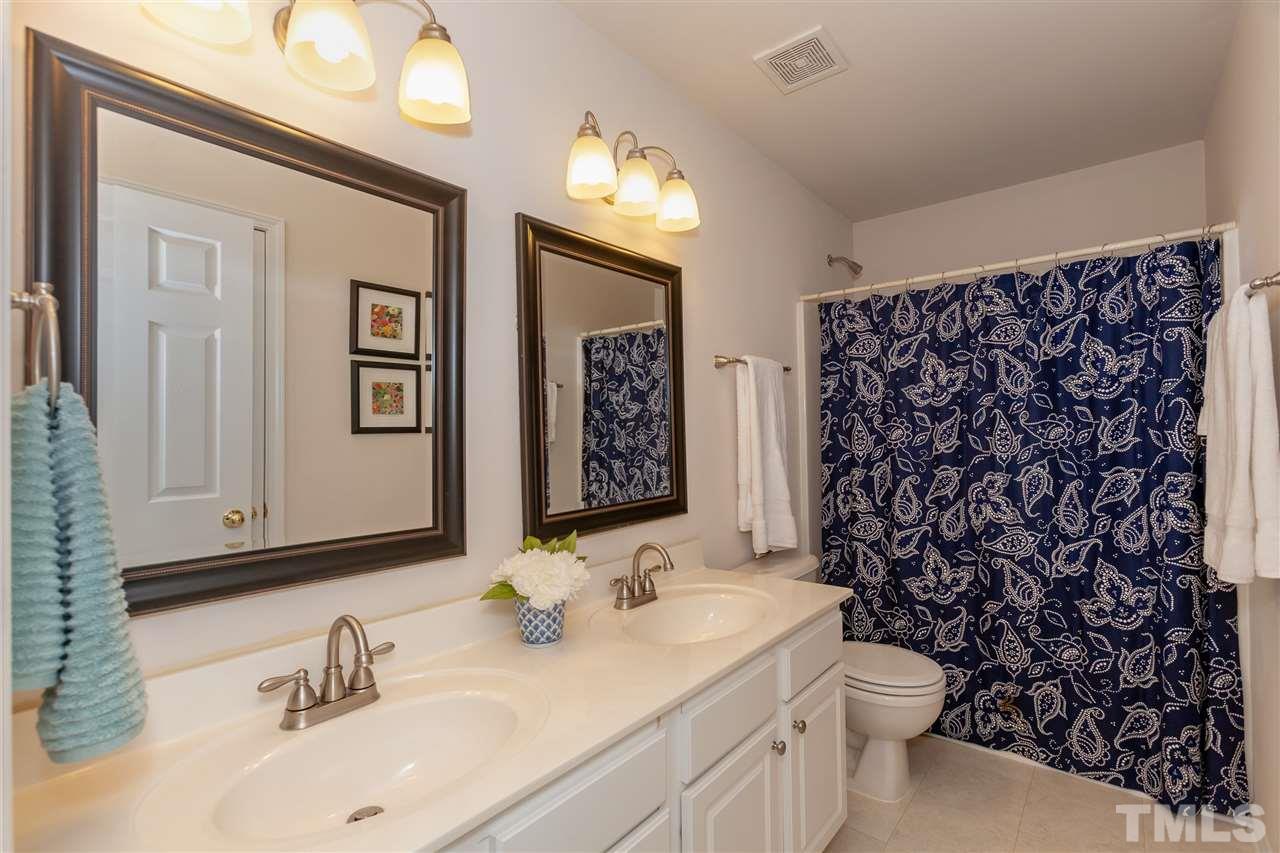 7331 Brandon Allen Avenue Raleigh, NC 27613 - Photo 16 of 25 The upstairs hall bath features a double vanity and a shower/tub combination.