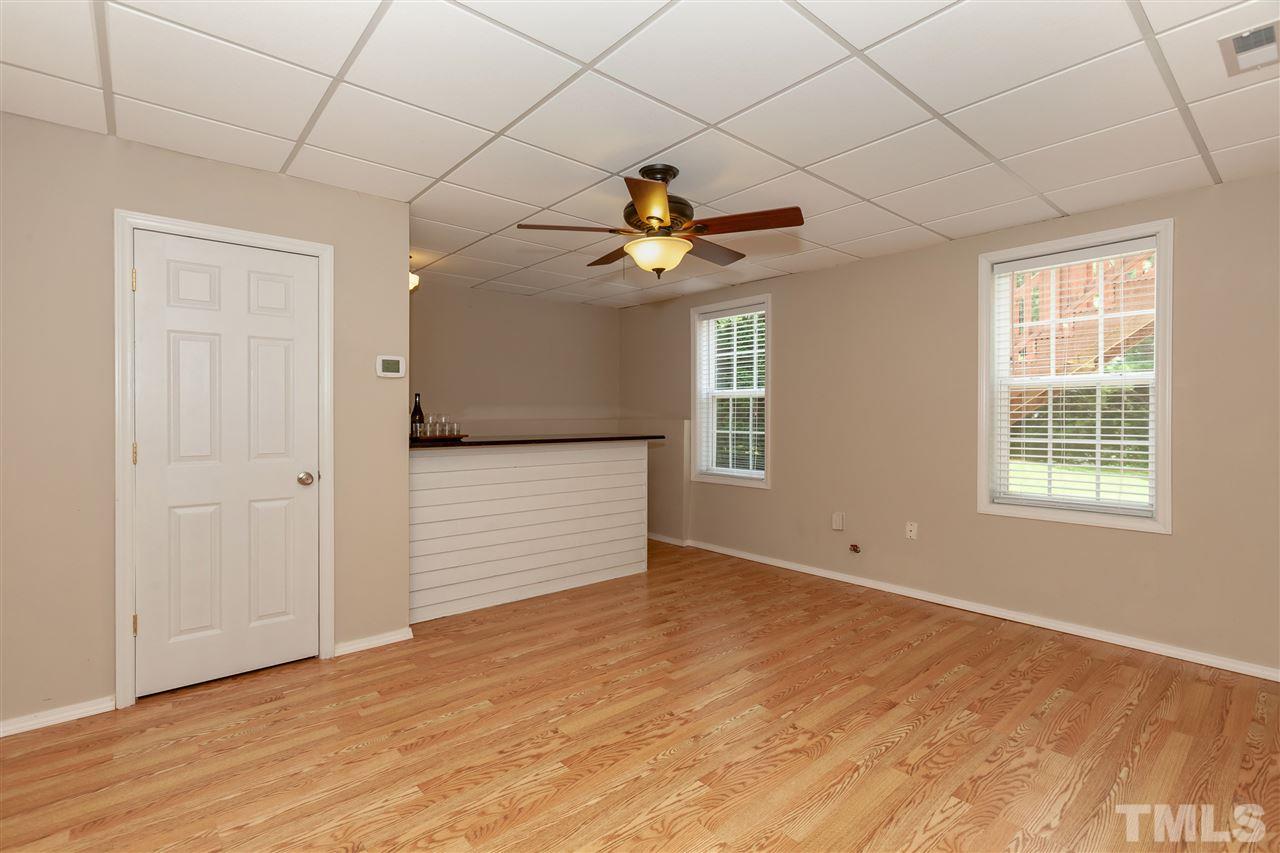 7331 Brandon Allen Avenue Raleigh, NC 27613 - Photo 17 of 25 The basement is so versatile - this space has a shiplap bar with granite and a sink behind the bar. It's a perfect spot for entertaining guests or could provide a private spot for multigenerational living.