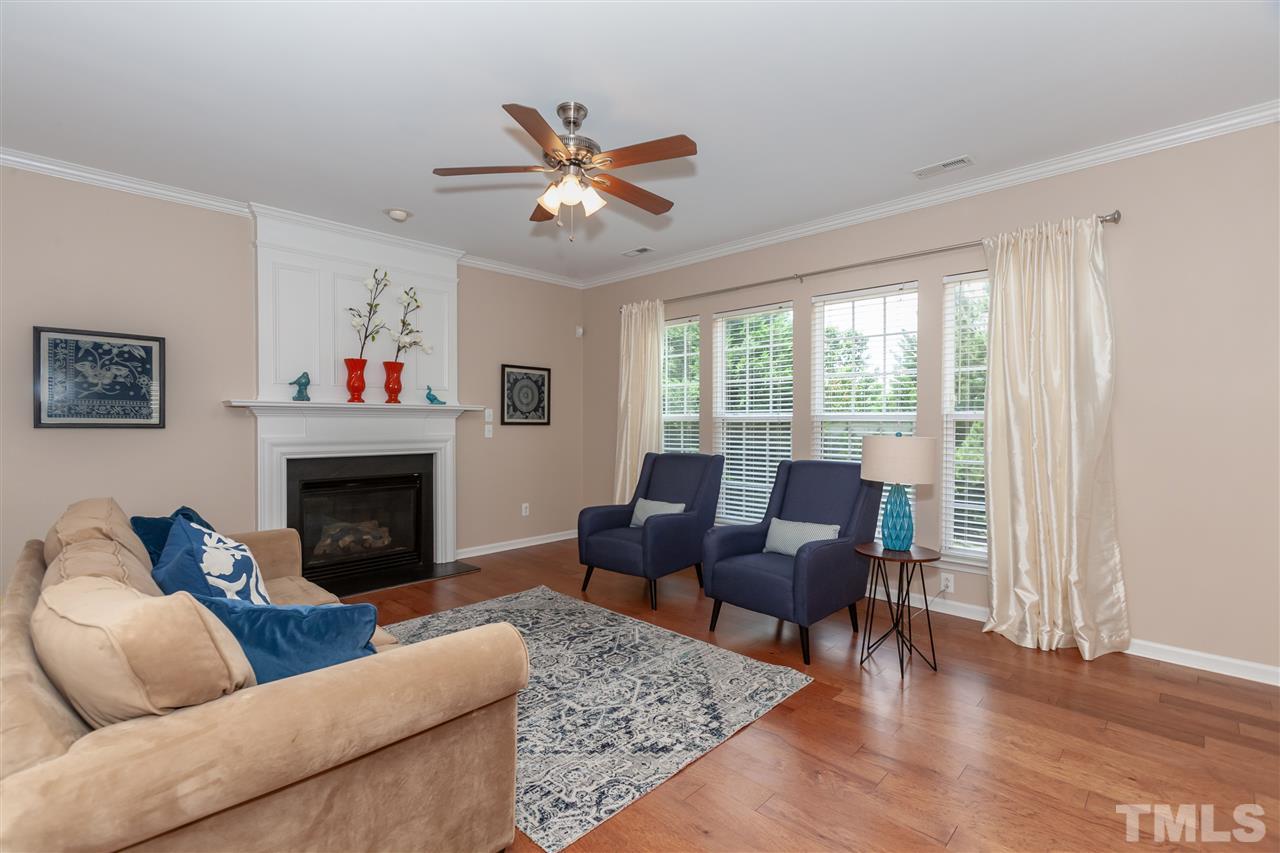 7331 Brandon Allen Avenue Raleigh, NC 27613 - Photo 3 of 25 Hickory floors in warm and inviting medium brown tone that's so popular now! Gas fireplace, enhanced crown molding, and neutral paint make this a space you'll love to show off!