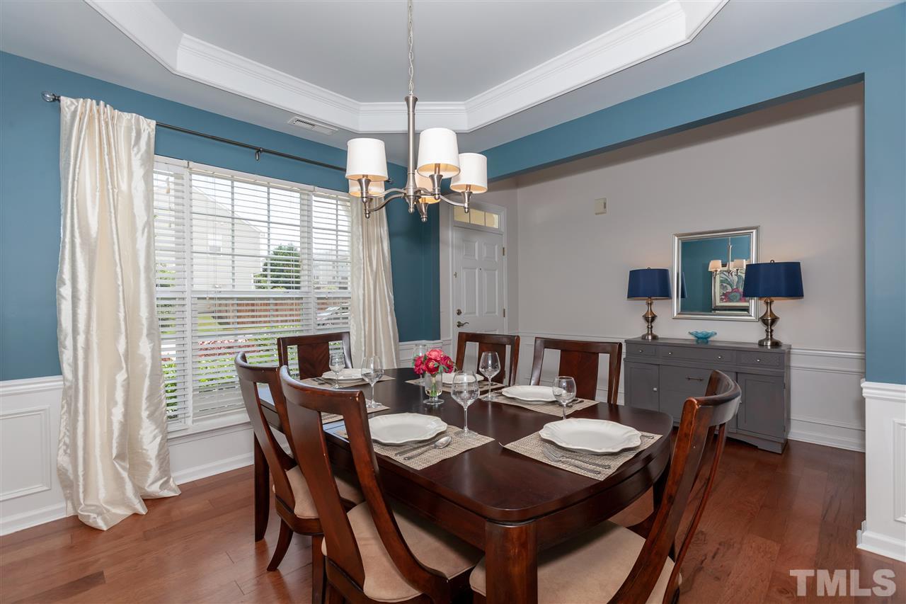 7331 Brandon Allen Avenue Raleigh, NC 27613 - Photo 8 of 25 The dining room features exceptional details such as wainscotting and a tray ceiling. The same 5-inch hickory floors found in kitchen, breakfast area, and living room flow into this space.