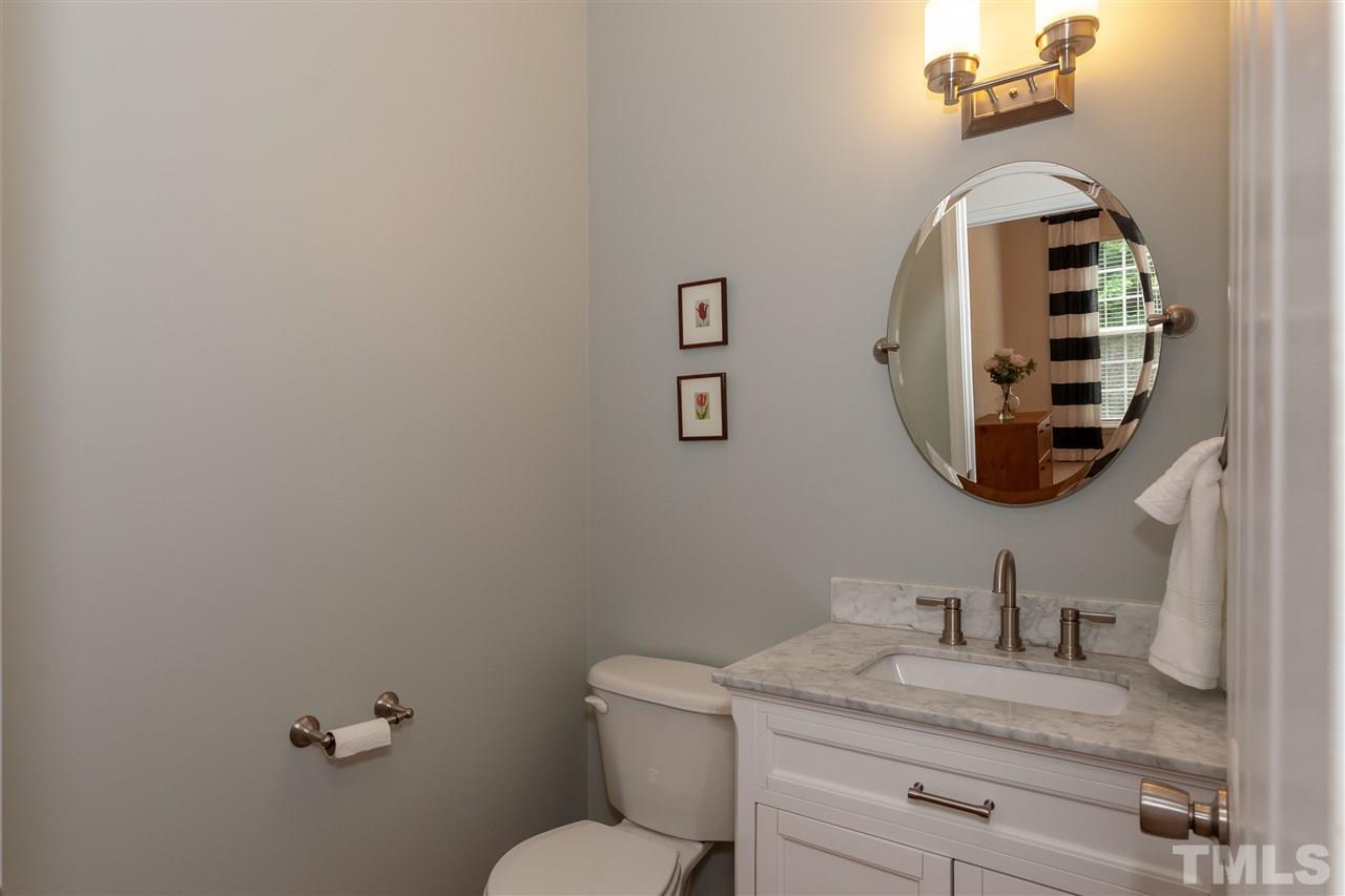 7331 Brandon Allen Avenue Raleigh, NC 27613 - Photo 10 of 25 First floor bath features newer vanity with soft-close doors, gorgeous top, and stylish accents.
