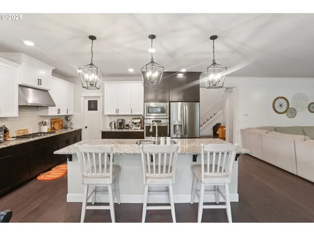 a large kitchen with a table and chairs