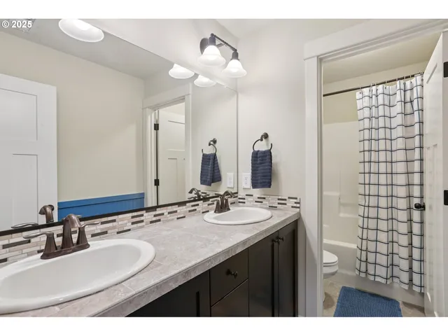 a bathroom with a double vanity sink mirror and double
